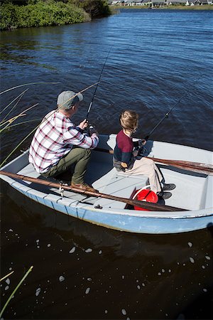 Happy man fishing with his son in the boat Photographie de stock - Aubaine LD & Abonnement, Code: 400-07991452