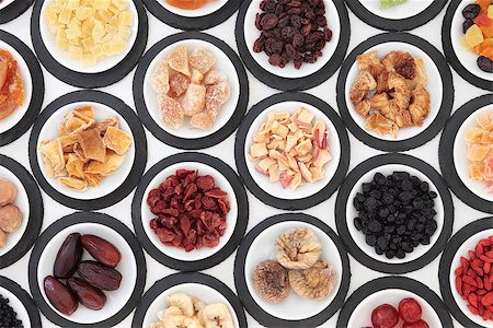 simsearch:400-07510855,k - Dried fruit selection in porcelain bowls on slate rounds over white background. Photographie de stock - Aubaine LD & Abonnement, Code: 400-07992887