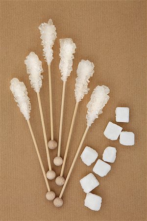 White sugar crystal lollipops with rough cut cubes over brown paper background. Photographie de stock - Aubaine LD & Abonnement, Code: 400-07992905