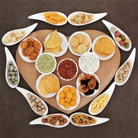 Savoury snack and dip party food selection in porcelain dishes  on a heart shaped wooden board. Stock Photo - Budget Royalty-Free & Subscription, Code: 400-07992958
