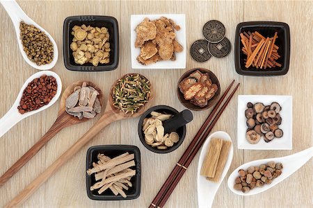 simsearch:400-07174356,k - Chinese herbal medicine selection with I ching coins, mortar with pestle and chopsticks over light oak background. Stock Photo - Budget Royalty-Free & Subscription, Code: 400-07992990