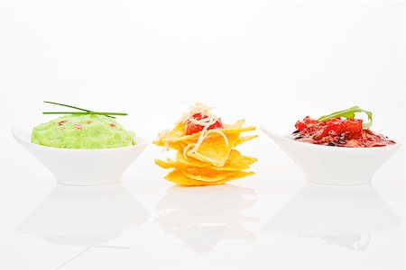 simsearch:400-07993657,k - Delicious nachos with guacamole and tomato sauce in bowls isolated on white background. Photographie de stock - Aubaine LD & Abonnement, Code: 400-07993454