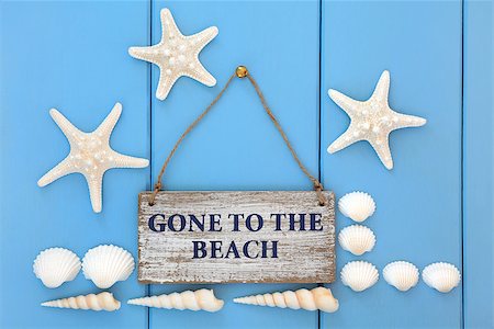 simsearch:400-07818974,k - Gone to the beach sign with starfish, cockle and turritella seashells over wooden blue background. Stock Photo - Budget Royalty-Free & Subscription, Code: 400-07993619