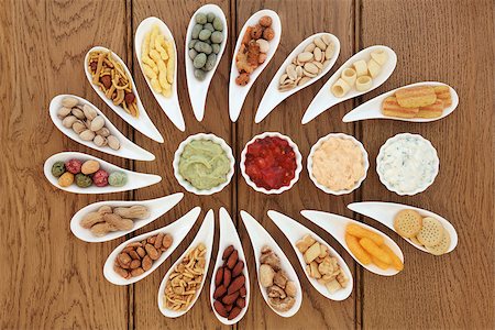 simsearch:400-07994208,k - Savoury snack and dip food selection in porcelain dishes over oak background. Photographie de stock - Aubaine LD & Abonnement, Code: 400-07993657