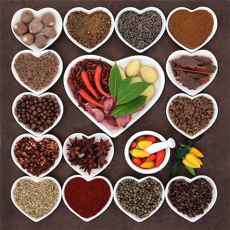 simsearch:400-06358844,k - Herb and spice ingredients in a heart shaped porcelain dishes and mortar with pestle. Photographie de stock - Aubaine LD & Abonnement, Code: 400-07993742