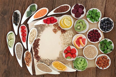 simsearch:400-08429907,k - Diet detox super food selection in porcelain bowls on a speckled hemp paper notebook over oak wood background. Fotografie stock - Microstock e Abbonamento, Codice: 400-07993827