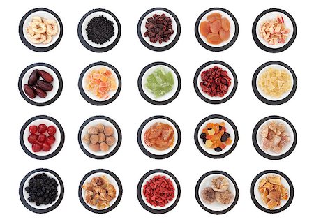 simsearch:400-07510855,k - Large dried fruit selection in white bowls on slate rounds over white background. Photographie de stock - Aubaine LD & Abonnement, Code: 400-07993833