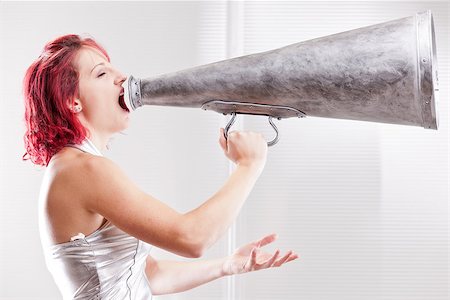 red haired vintage space costume girl shouting in a vintage megaphone Stock Photo - Budget Royalty-Free & Subscription, Code: 400-07993869