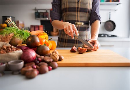 Closeup on young housewife cutting cherokee purple tomato Stock Photo - Budget Royalty-Free & Subscription, Code: 400-08015734