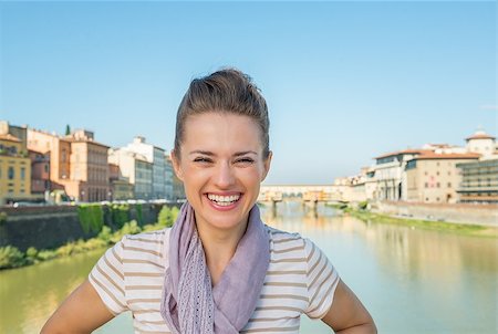 simsearch:400-08016330,k - Portrait of smiling young woman standing on bridge overlooking ponte vecchio in florence, italy Stock Photo - Budget Royalty-Free & Subscription, Code: 400-08016300