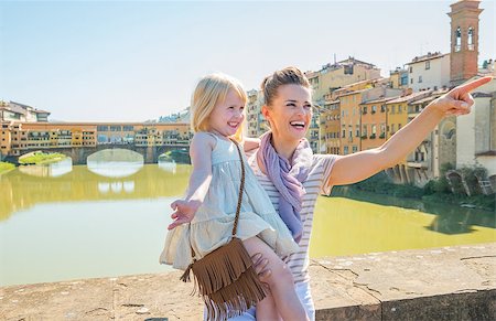 simsearch:400-08134687,k - Happy mother and baby girl standing on bridge overlooking ponte vecchio in florence, italy and pointing Stock Photo - Budget Royalty-Free & Subscription, Code: 400-08016324