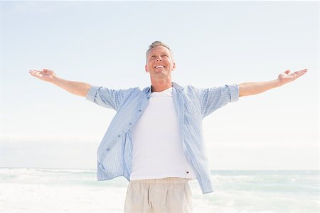 simsearch:6109-07496983,k - Handsome man with arms outstretched at the beach Stock Photo - Budget Royalty-Free & Subscription, Code: 400-08017150