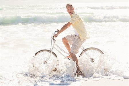 Happy man on a bike ride at the beach Stock Photo - Budget Royalty-Free & Subscription, Code: 400-08017219