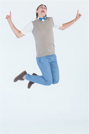 Geeky hipster jumping and smiling on white background Stock Photo - Budget Royalty-Free & Subscription, Code: 400-08017572