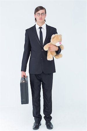 simsearch:400-08020381,k - Geeky businessman holding briefcase and teddy on white background Fotografie stock - Microstock e Abbonamento, Codice: 400-08017634