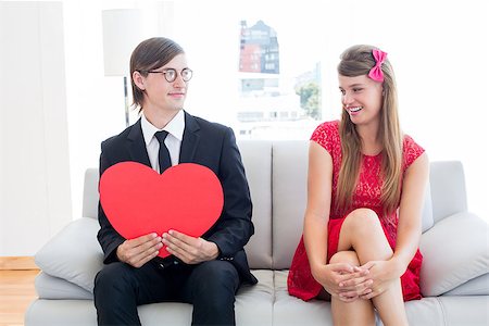 simsearch:400-07686530,k - Cute geeky couple with red heart shape on the couch Foto de stock - Royalty-Free Super Valor e Assinatura, Número: 400-08017661
