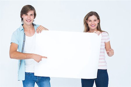 Hipster couple holding poster on white background Stock Photo - Budget Royalty-Free & Subscription, Code: 400-08017746