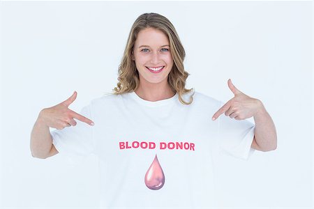 Blood donor showing her t-shirt on white background Stock Photo - Budget Royalty-Free & Subscription, Code: 400-08017838