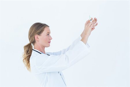 doctor preparing shot - Serious doctor preparing syringe on white background Stock Photo - Budget Royalty-Free & Subscription, Code: 400-08017889