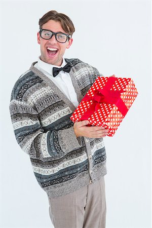 Happy geeky hipster with wool jacket holding present on white jacket Stock Photo - Budget Royalty-Free & Subscription, Code: 400-08017978