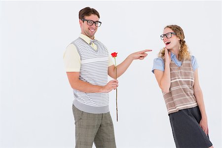 simsearch:400-08380794,k - Geeky hipster holding rose and pointing his girlfriend on white background Stockbilder - Microstock & Abonnement, Bildnummer: 400-08018055