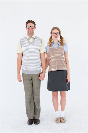 simsearch:400-08380794,k - Smiling geeky hipster couple holding hands on white background Stockbilder - Microstock & Abonnement, Bildnummer: 400-08018058