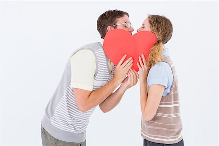 simsearch:400-08380794,k - Geeky hipster couple kissing behind heart card on white background Stockbilder - Microstock & Abonnement, Bildnummer: 400-08018053