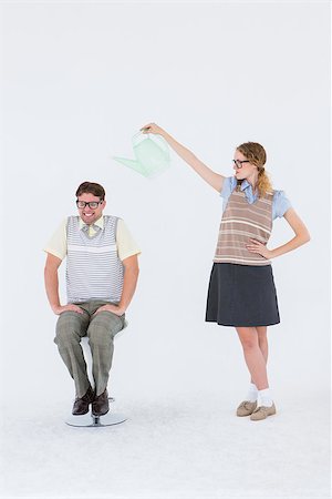 simsearch:400-08380794,k - Geeky hipster holding watering can above her boyfriend on white background Stockbilder - Microstock & Abonnement, Bildnummer: 400-08018067