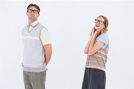simsearch:400-08380794,k - Geeky hipster couple looking at camera on white background Stockbilder - Microstock & Abonnement, Bildnummer: 400-08018068