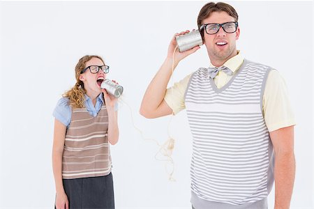 simsearch:400-08380794,k - Geeky hipster couple speaking with tin can phone on white background Stockbilder - Microstock & Abonnement, Bildnummer: 400-08018061