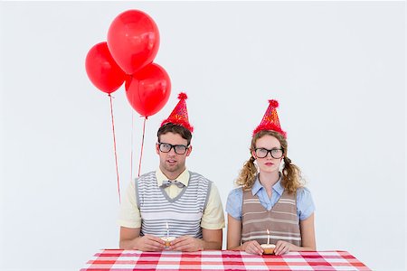 simsearch:400-08380794,k - Geeky hipster couple celebrating his birthday on white background Stockbilder - Microstock & Abonnement, Bildnummer: 400-08018074