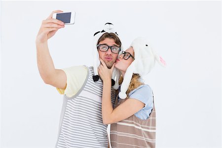 simsearch:400-08380794,k - Geeky hipster couple taking selfie with smartphone on white background Stockbilder - Microstock & Abonnement, Bildnummer: 400-08018077