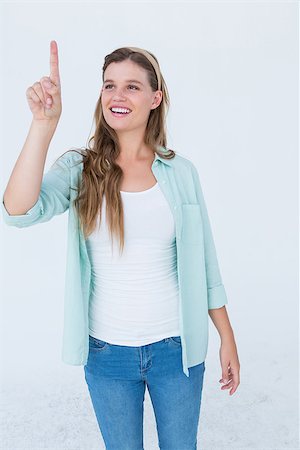 Pretty hipster pointing with her finger on white background Stock Photo - Budget Royalty-Free & Subscription, Code: 400-08018304