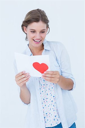Smiling woman reading love letter on white background Stock Photo - Budget Royalty-Free & Subscription, Code: 400-08018340