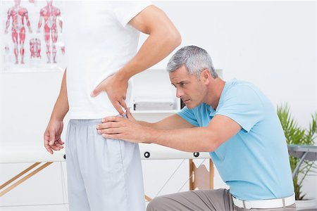 simsearch:400-08018430,k - Doctor examining his patient back in medical office Photographie de stock - Aubaine LD & Abonnement, Code: 400-08018494