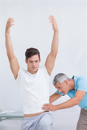 simsearch:400-08018430,k - Doctor examining his patient back in medical office Photographie de stock - Aubaine LD & Abonnement, Code: 400-08018509