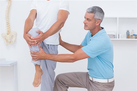 simsearch:400-08018430,k - Doctor examining his patient legs in medical office Photographie de stock - Aubaine LD & Abonnement, Code: 400-08018513