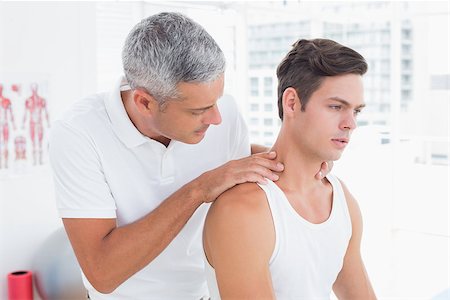 simsearch:400-08018430,k - Doctor examining his patient neck in medical office Photographie de stock - Aubaine LD & Abonnement, Code: 400-08018584