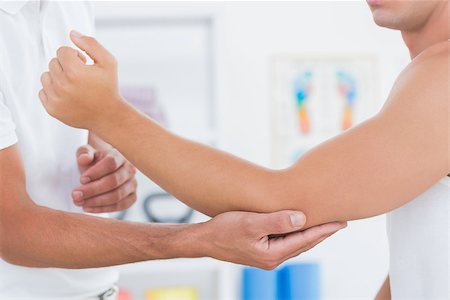 simsearch:400-08018430,k - Doctor examining his patient arm in medical office Photographie de stock - Aubaine LD & Abonnement, Code: 400-08018603