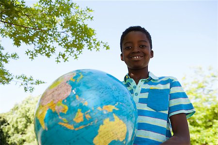 Cute little boy with globe on a sunny day Stock Photo - Budget Royalty-Free & Subscription, Code: 400-08019099