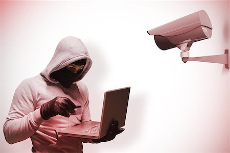 Hacker using laptop to steal identity against cctv camera Stock Photo - Budget Royalty-Free & Subscription, Code: 400-08019187