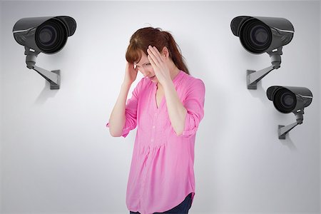 simsearch:400-07833287,k - Worried redhead against cctv camera Stock Photo - Budget Royalty-Free & Subscription, Code: 400-08019212