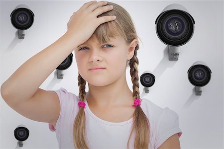 simsearch:400-06885115,k - Little girl suffering from headache against cctv camera Photographie de stock - Aubaine LD & Abonnement, Code: 400-08019222