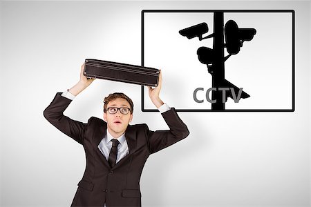 simsearch:400-08020381,k - Young geeky businessman holding briefcase against cctv Fotografie stock - Microstock e Abbonamento, Codice: 400-08019244