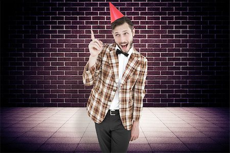 simsearch:400-08020381,k - Geeky hipster in party hat  against purple vignette Fotografie stock - Microstock e Abbonamento, Codice: 400-08019259