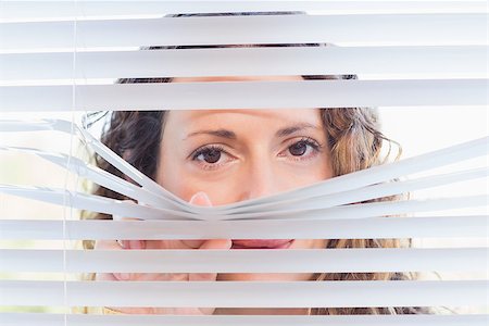 Curious woman looking through blinds in the house Stock Photo - Budget Royalty-Free & Subscription, Code: 400-08019458
