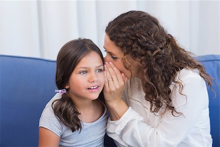 Mother and daughter whispering in the living room Stock Photo - Budget Royalty-Free & Subscription, Code: 400-08019515