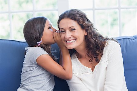 Mother and daughter whispering in the living room Stock Photo - Budget Royalty-Free & Subscription, Code: 400-08019516