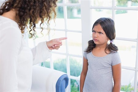 simsearch:877-07460598,k - Angry little girl looking at her mother in the living room Stock Photo - Budget Royalty-Free & Subscription, Code: 400-08019512