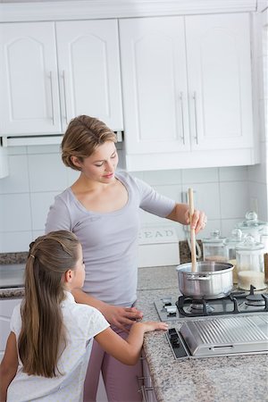 Mother and daughter cooking together at home in kitchen Stock Photo - Budget Royalty-Free & Subscription, Code: 400-08019946